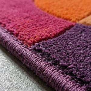 Close-up of rug edge showing clean finishing and thick tufted border.