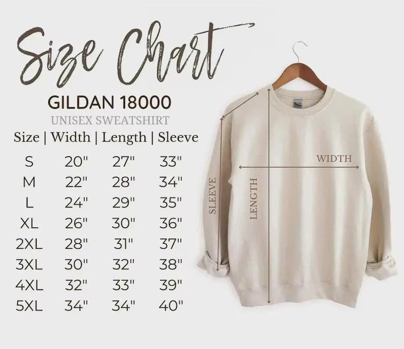 May include: A beige Gildan 18000 unisex sweatshirt hangs on a wooden hanger. The image includes a size chart with measurements in inches for width, length, and sleeve length, ranging from size small to 5XL.