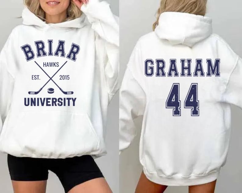 May include: White hoodie with navy blue text and graphics. The front features "Briar Hawks University" with crossed hockey sticks and a puck. The back displays "Graham" and the number "44".