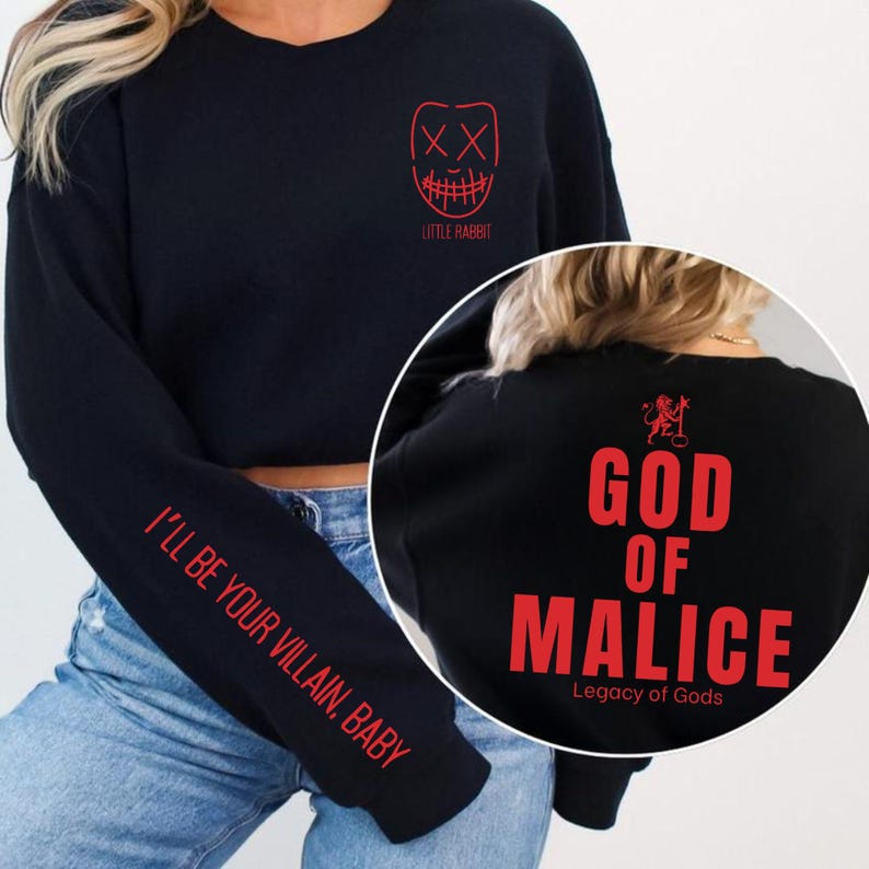 May include: Black sweatshirt with red text and graphics. The front features a mask design and the words "LITTLE RABBIT." The left sleeve reads "I'LL BE YOUR VILLAIN, BABY." The back says "GOD OF MALICE" and "Legacy of Gods."