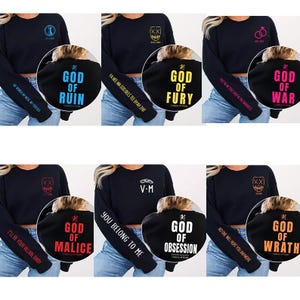 May include: A collection of black long-sleeve sweatshirts with various designs. Each sweatshirt features a different graphic on the back, such as "God of Ruin," "God of Fury," and "God of War." The sleeves have text like "My Home, My Wife, My Forever."