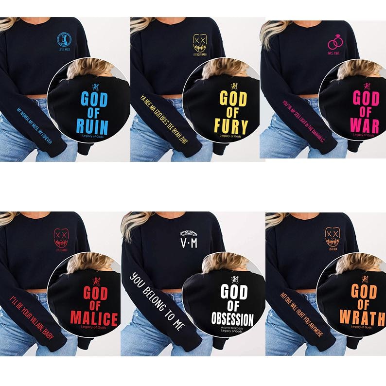 May include: A collection of black long-sleeve sweatshirts with various designs. Each sweatshirt features a different graphic on the back, such as "God of Ruin," "God of Fury," and "God of War." The sleeves have text like "My Home, My Wife, My Forever."
