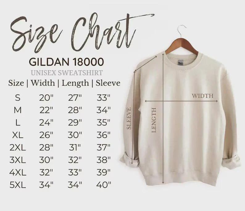 May include: A beige Gildan 18000 unisex sweatshirt hangs on a wooden hanger. The image includes a size chart with measurements in inches for width, length, and sleeve length, ranging from size small to 5XL.