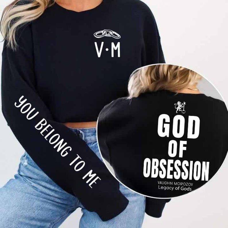 May include: Black sweatshirt with white text and graphics. The left sleeve reads "YOU BELONG TO ME." The front features "V&bull;M" and a chain graphic. The back displays "GOD OF OBSESSION" and "VAUGHN MOROZOV Legacy of Gods."