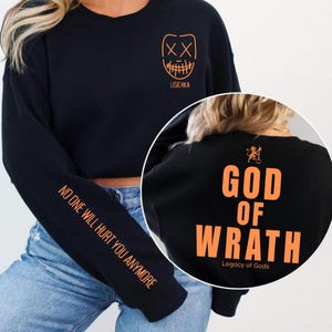 May include: Black sweatshirt with orange graphics. The front features a mask design and the name "LISICHKA". The left sleeve reads "NO ONE WILL HURT YOU ANYMORE". The back displays "GOD OF WRATH" and "Legacy of Gods".