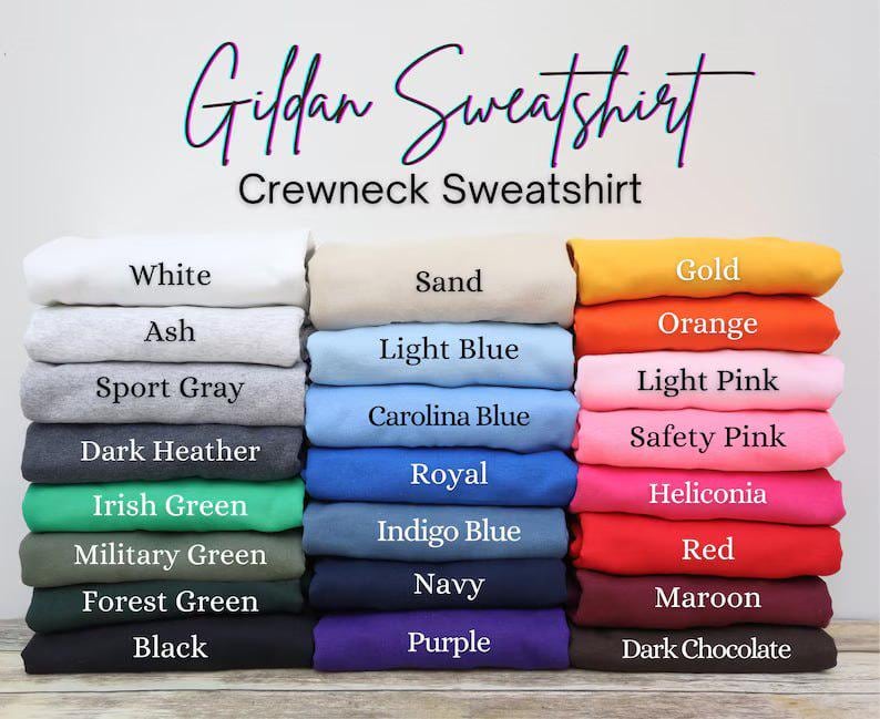 May include: A stack of Gildan crewneck sweatshirts in various colors, including white, black, and navy. The image displays a range of hues, from light pink to dark chocolate, with the names of each color printed below.