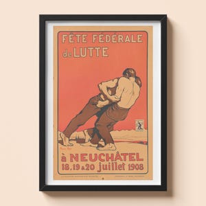 Puede incluir: Póster vintage enmarcado que anuncia la Fête Fédérale de Lutte en Neuchâtel, Suiza. El póster presenta a dos luchadores en acción sobre un fondo rojo. El texto incluye el nombre y la fecha del evento.