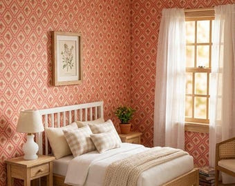 May include: A miniature bedroom scene featuring a wooden bed frame with white bedding, a beige knit throw, and plaid pillows. A wooden nightstand holds a white lamp, while a framed botanical print hangs on coral patterned wallpaper.