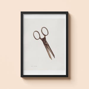 May include: Framed print of vintage scissors. The scissors are depicted in a watercolor style, with a brown and bronze color scheme. The scissors are open, with the blades angled downward. The frame is black, and the background is white.