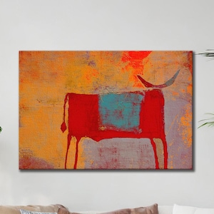 May include: Abstract art print depicting a red bull with a turquoise square on its body. The background has orange, yellow, and grey tones. The bull has long legs and a curved horn. Suitable for home decor.