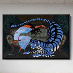 May include: A framed art print depicting a woman and a blue tiger. The woman is in a light blue dress, reclining on a sofa. The tiger has blue and white stripes. The artwork is set against a dark background.