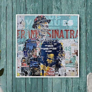 May include: A framed artwork featuring a collage of images and text, with a central portrait of Frank Sinatra. The artwork includes the text "FRANK SINATRA" and "The Joker Wild". The color palette includes blue, red, and white.