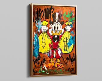 May include: Framed artwork featuring a cartoon character holding two large yellow money bags with dollar signs. The character is dressed in a red coat, black top hat, and bow tie. The background is brown with graffiti-style text and colorful paint splatters.
