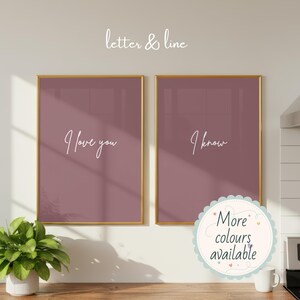 May include: Two rectangular wall art prints in thin gold frames with a dusty rose background. The left print features the white text I love you, and the right print features the white text I know. Above the prints is the text letter & line.
