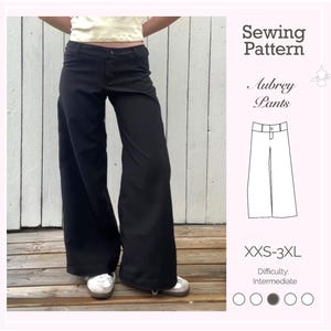 May include: Black wide-leg pants with a high waist. The pants are worn with a light-colored top and white shoes. The image includes a sewing pattern illustration of the Aubrey Pants, with the text "Sewing Pattern" and "Aubrey Pants". The pattern sizes range from XXS-3XL.