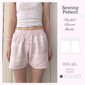 May include: Pink and white patterned boxer shorts with a button closure. The shorts are part of a sewing pattern labeled "Rachel Boxer Shorts" with sizes XXS-3XL and beginner difficulty.