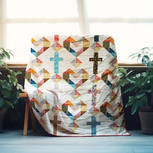 May include: A handmade quilt featuring a repeating pattern of colorful geometric shapes and crosses in various colors. The quilt is draped over a wooden bench, with a window and plants in the background. The quilt's border is red.