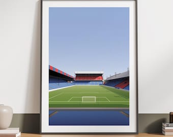 May include: Framed art print of a soccer stadium with a green field, blue seating, and red and black accents under a clear blue sky. The artwork is displayed on a wooden surface.