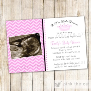 May include: Pink and white chevron patterned baby shower invitation with a black border. The invitation features a crown and the text "A New Little Princess is on her way". The invitation also includes a black and white ultrasound image.