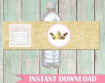 May include: Printable water bottle label with a gold glitter background and a pink circle with a gold crown. The label says "Nutrition Facts" and lists items like "Family", "Friends", "Laughter", and "Happiness" with a 100% daily value. The label also says "Instant Download".
