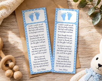 May include: Two rectangular paper bookmarks with a light blue and white polka dot border. Each features a pair of light blue baby footprints at the top and a poem addressed to Mom and Dad, ending with the name Ethan, printed in black text.