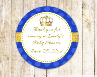 May include: Round blue and gold thank you sticker with white polka dots. The sticker features a gold crown and the text "Thank you for coming to Emily's Baby Shower June 25, 20xx".