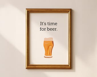 May include: A framed print with the text "It's time for beer." above a watercolor illustration of a beer glass. The frame is gold-colored, and the background is off-white.