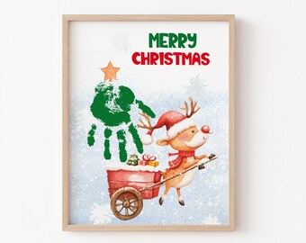 May include: A framed Christmas print featuring a handprint tree, a reindeer pulling a cart with gifts, and the words "Merry Christmas" in red and green. The reindeer wears a Santa hat and scarf. The background is a light blue with snowflakes.