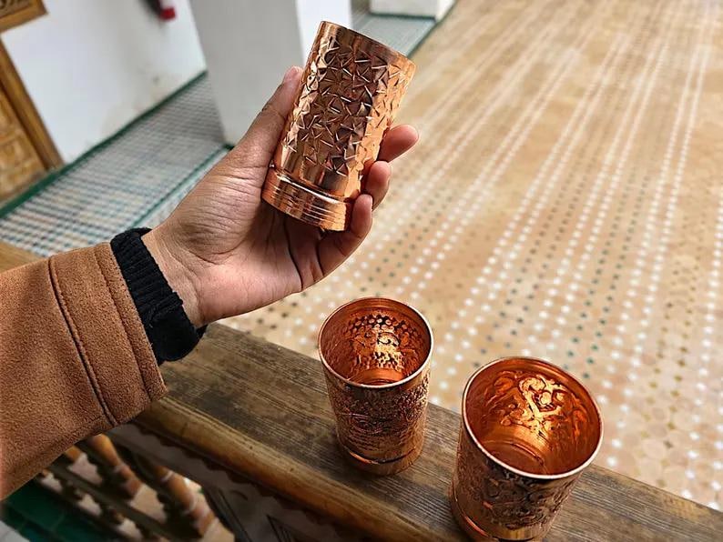 Set of three copper tumblers shown as a 7th wedding anniversary gift.