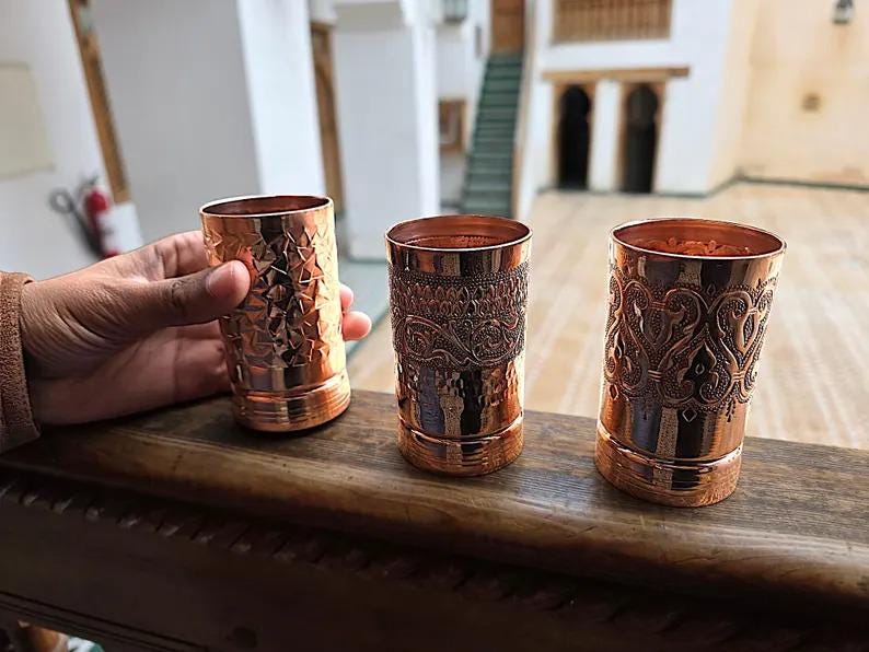 A view of the smooth, rounded rim of the pure copper tumbler.