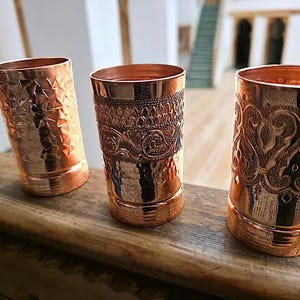 Pure copper tumblers set of 3 with distinct embossed and hammered patterns.