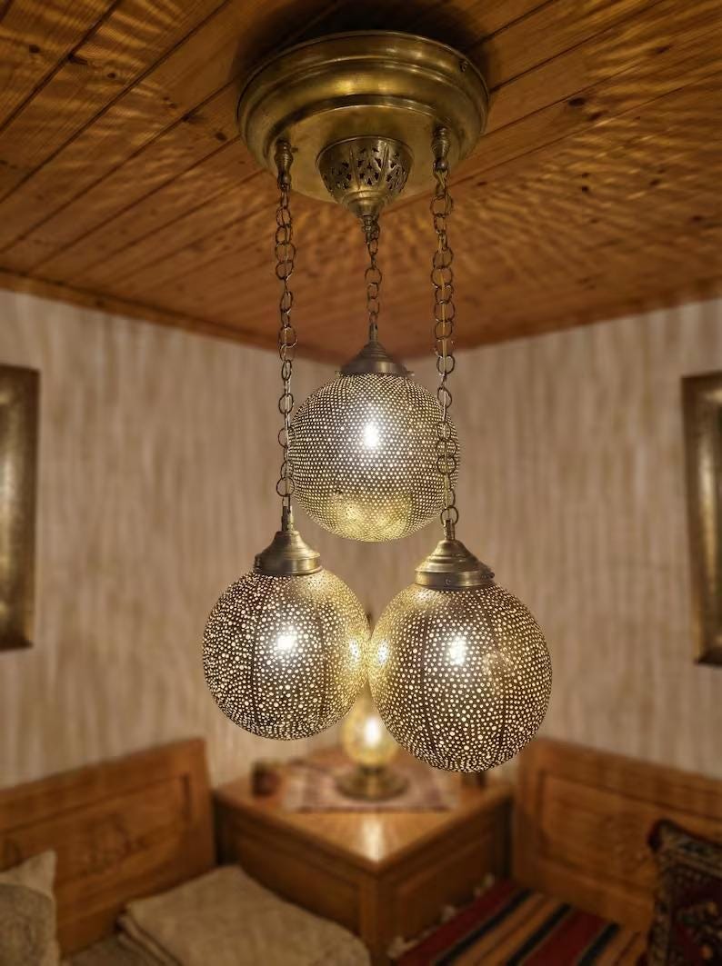 Detailed view of the brass ceiling canopy and chain links.