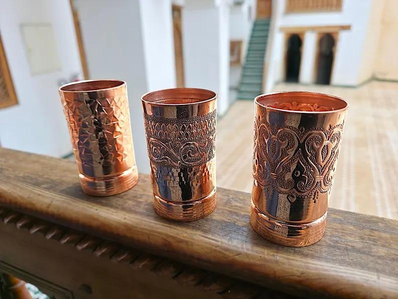 High-quality image showing the hand-hammered texture of one copper cup.