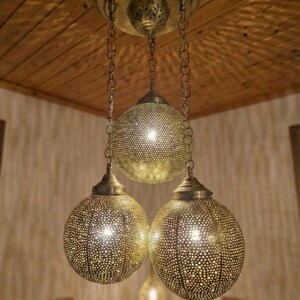 Boho style bedroom lighting fixture with gold finish.