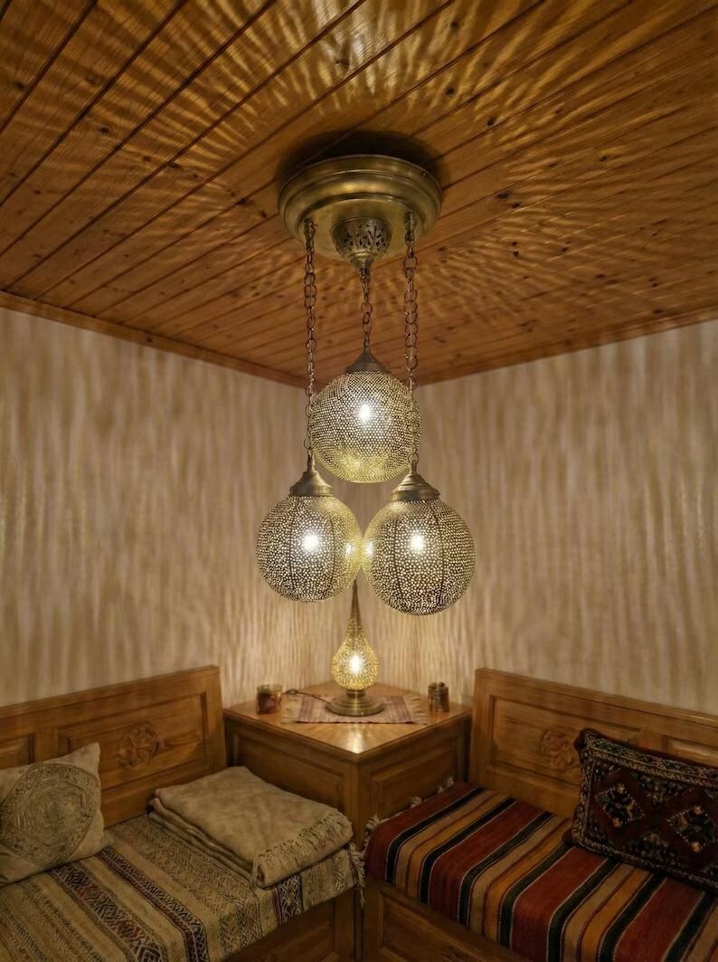 Close up of handmade perforated holes in brass lamp shade.
