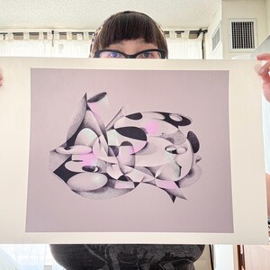 May include: Abstract art print with a complex arrangement of geometric shapes in black, white, and pink. The artwork has a soft, diffused appearance, with subtle shading and highlights. The print is displayed on a light pink background.