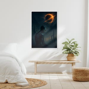 May include: A framed art print depicts a somber figure beneath a fiery celestial body. The artwork features a dark, atmospheric scene with a palette of blues, grays, and oranges, evoking a sense of mystery and introspection. The print is displayed on a white wall.