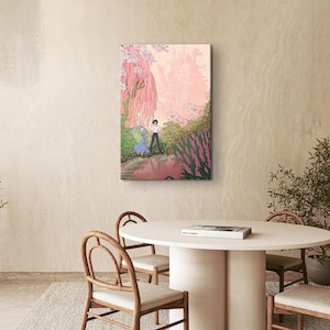 May include: A framed canvas art print depicting a romantic scene in a garden. The artwork features two figures, one in a blue dress and the other in a white shirt, walking near a pond. The color palette includes pinks, greens, and soft tones.