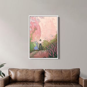 May include: A framed art print depicts a romantic scene with two figures in a garden. The artwork features a soft color palette of pinks, greens, and blues, with a castle in the background. The print is displayed above a brown leather sofa.