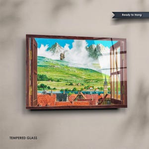 May include: Tempered glass wall art featuring a scenic landscape viewed through a wooden window frame. The artwork depicts a village with red-tiled roofs, a lake, and mountains under a blue sky. The text "Ready to Hang" is visible.