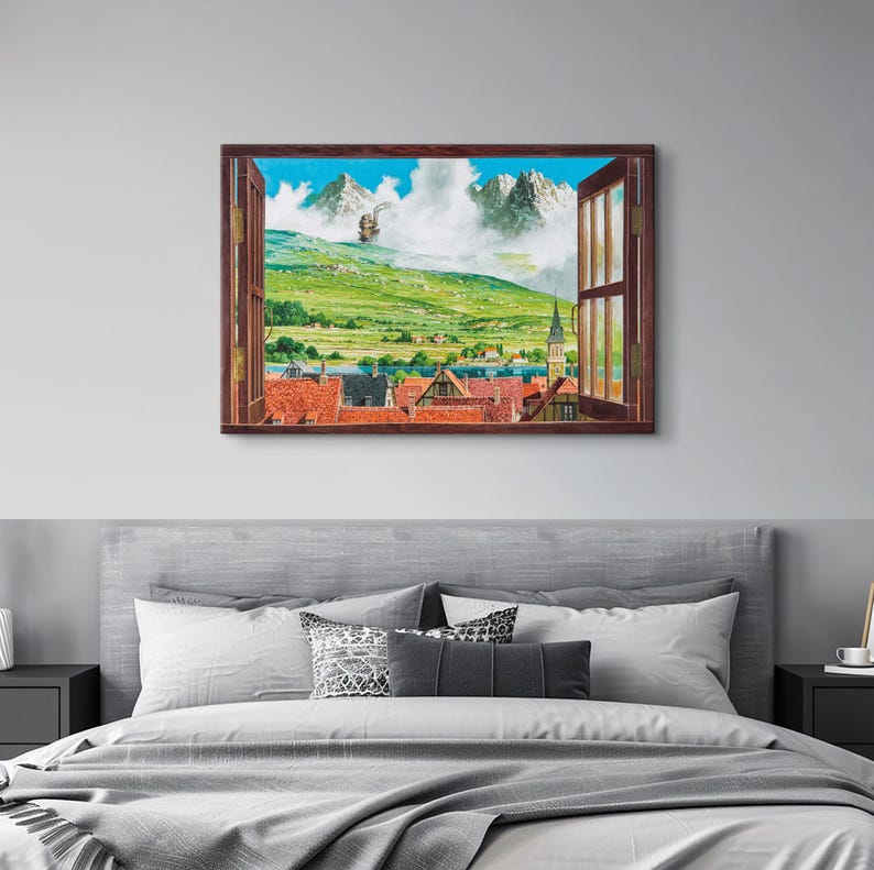 May include: A framed watercolor painting depicts a scenic view through an open window. The artwork showcases a vibrant landscape with green hills, snow-capped mountains, and a quaint village with red-tiled roofs. The window frame is a warm brown.