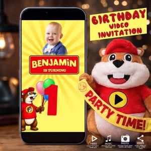May include: A smartphone displays a birthday video invitation for Benjamin's first birthday. The design features a smiling baby, a cartoon beaver holding balloons, and the text "BENJAMIN IS TURNING 1". A plush beaver holds a banner that says "PARTY TIME!"