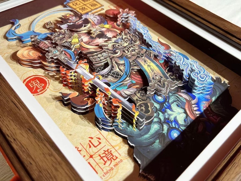 May include: A detailed, multi-layered paper art piece depicting a warrior figure with a sword, in shades of blue, gold, and red. The artwork is framed in a wooden frame and features Chinese characters and symbols. The word "KUI" is visible.