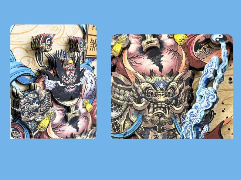 May include: Close-up of a detailed, multi-layered paper art piece featuring two mythical figures. The artwork showcases intricate designs with a color palette of black, gold, blue, and red. The figures have detailed facial features and ornate armor.