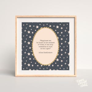 May include: A framed print with a light wood frame. The artwork features a dark blue background with white stars. An oval shape in the center contains a quote by Albus Dumbledore in black text. The quote reads: "Happiness can be found in the darkest of times, if one only remembers to turn on the light."