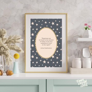 May include: A framed print with a gold border features a quote by Albus Dumbledore on a starry background. The quote reads, "Happiness can be found in the darkest of times, if one only remembers to turn on the light."