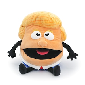 May include: A plush doll with a cartoonish design, featuring a large head with blonde hair, big eyes, and a wide open mouth. The doll has black arms and legs, and is wearing a white shirt with a red tie and a blue jacket.