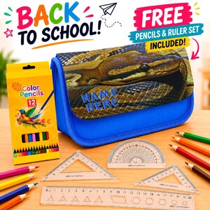 May include: A blue pencil case with a snake print flap featuring the text NAME HERE, accompanied by a yellow box of 12 colour pencils, a 20 cm ruler, two clear plastic triangles, and a protractor, with text BACK TO SCHOOL and FREE PENCILS & RULER SET.