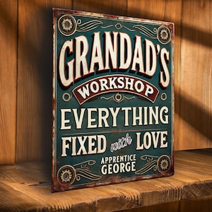 May include: A distressed metal sign, teal in colour, with the words "GRANDAD'S WORKSHOP" in white. It also reads "EVERYTHING FIXED with LOVE" and "APPRENTICE GEORGE". The sign has a vintage aesthetic, with a worn and aged appearance.