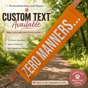 May include: An orange dog lead sleeve with the words "ZERO MANNERS..." in white. It features a brown leather strap and a metal clasp. The text "CUSTOM TEXT Available" is also visible.